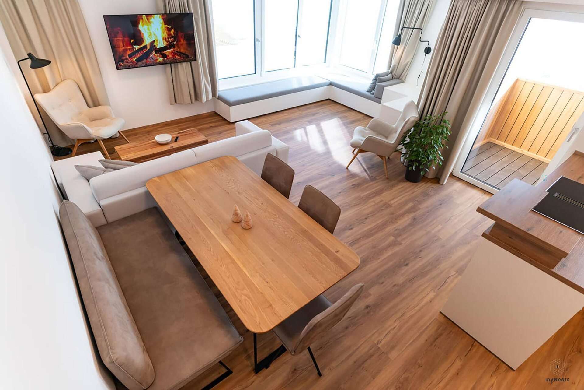 Jídelní stůl s rohovou lavicí před obývací částí v apartmánu Amsel 5