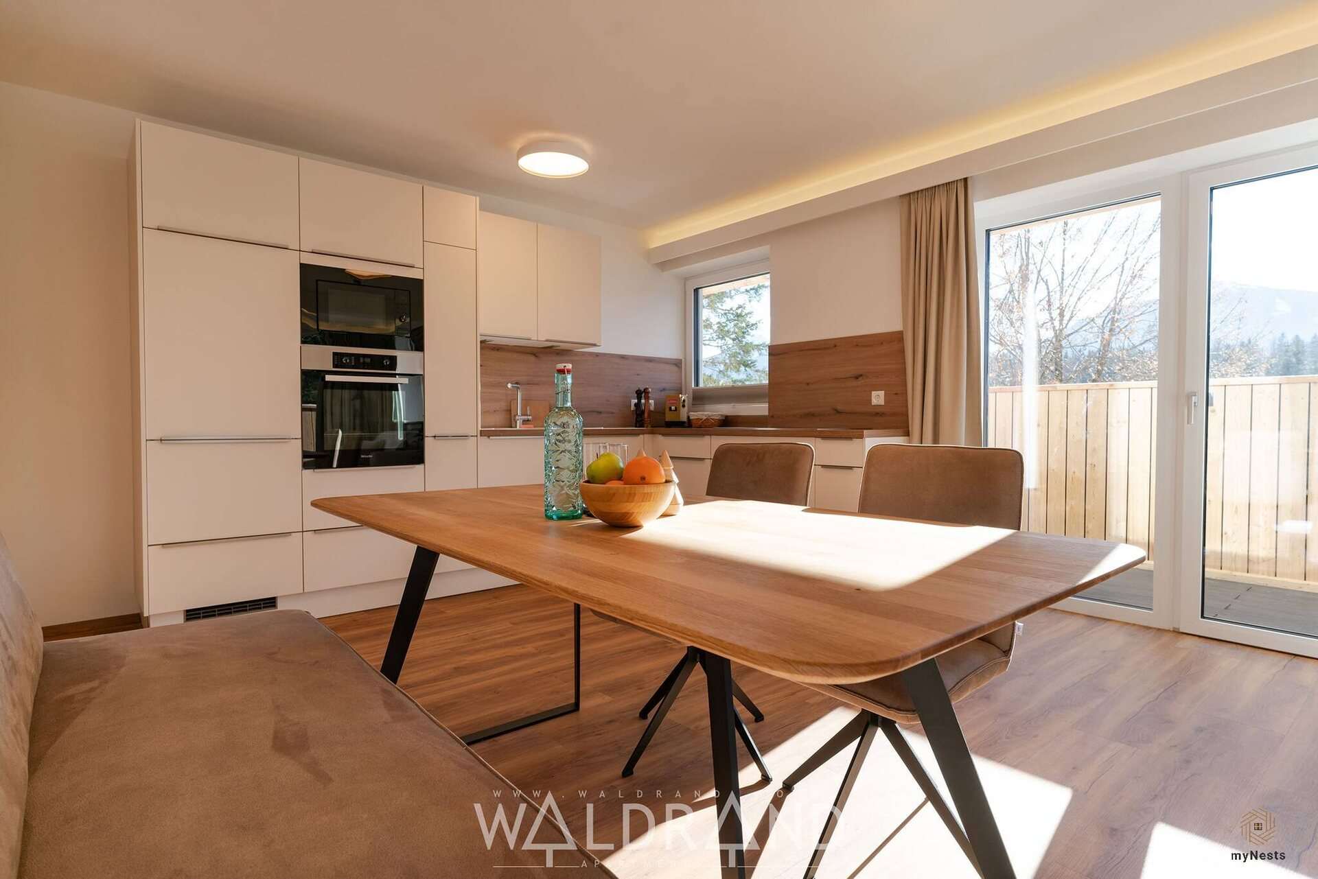 Holzesstisch mit Obstschale vor der Küche im Apartment Kuckuck 7